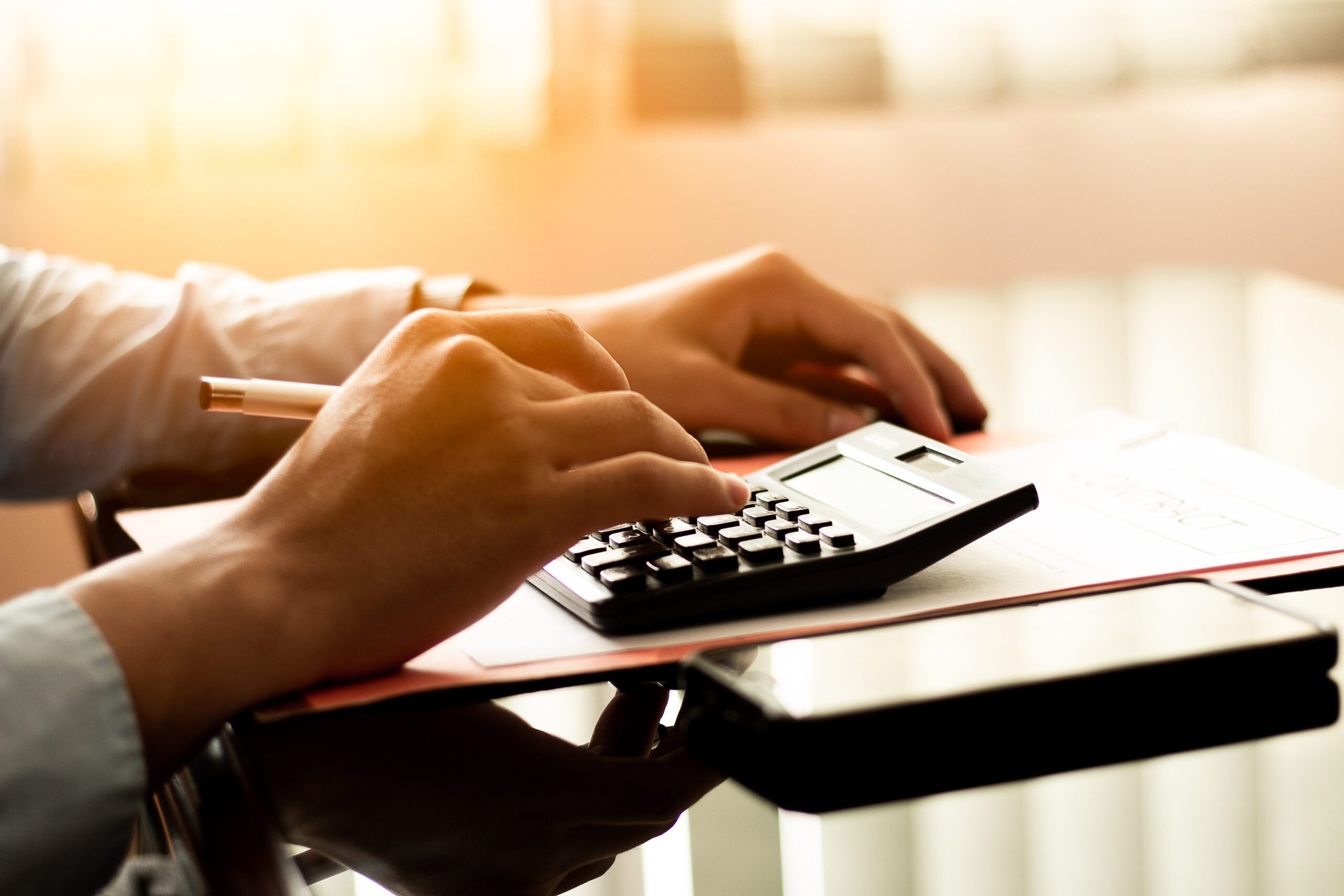 business-man-using-calculator-with-laptop-budget-loan-paper-office