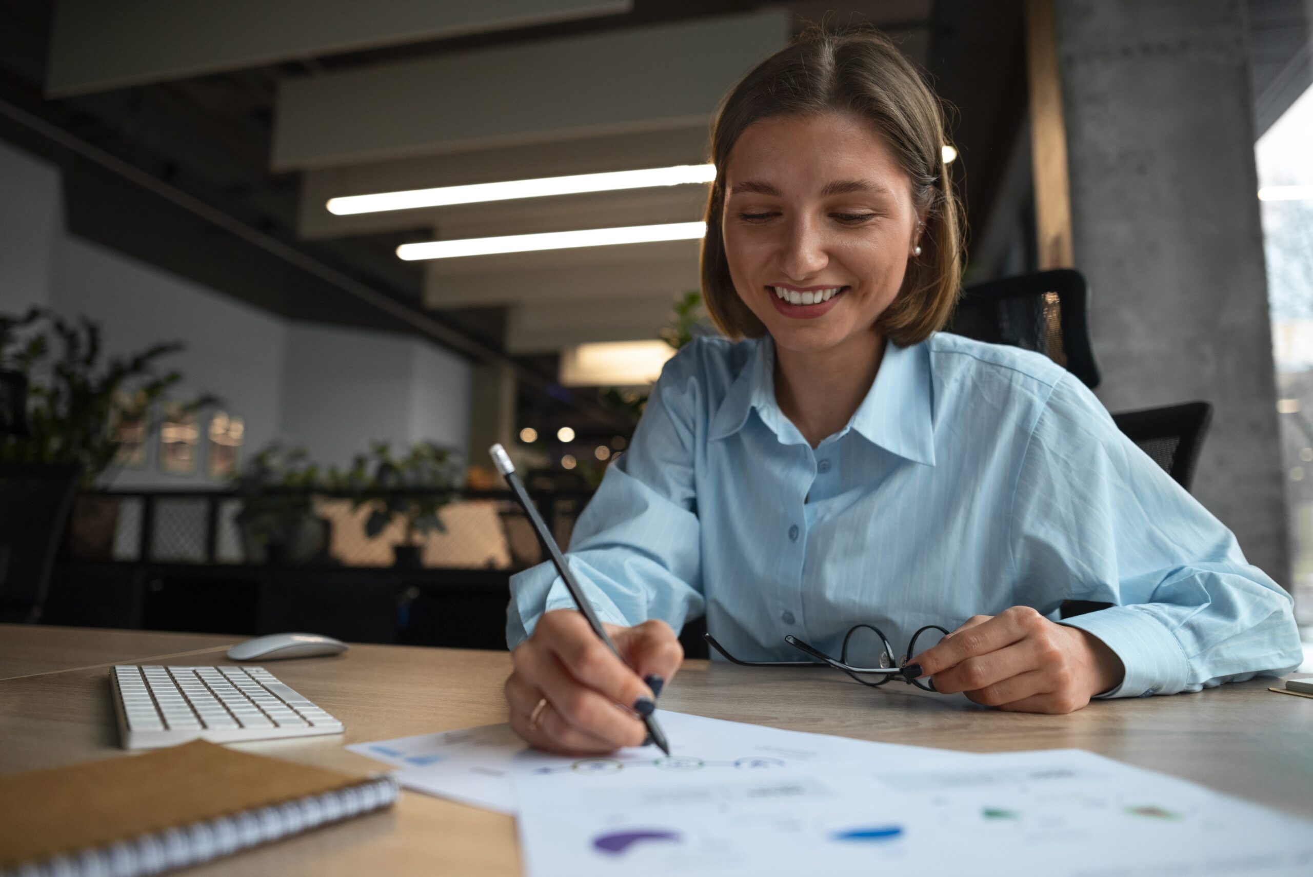 obsidian-contact-page-business-professional Professional woman at desk reviewing documents in a modern office – contact the Obsidian team today